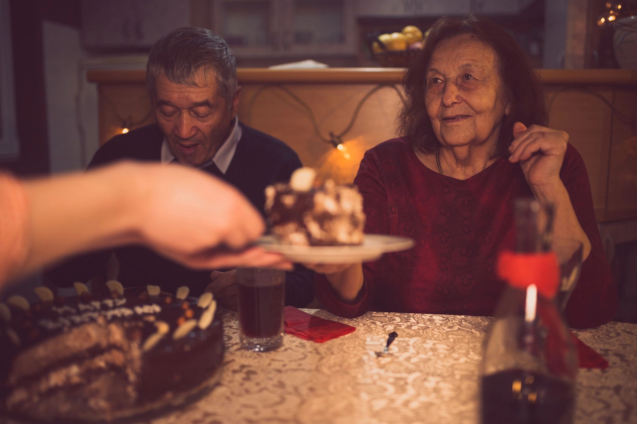Warm living room with seniors and staff sharing a laugh